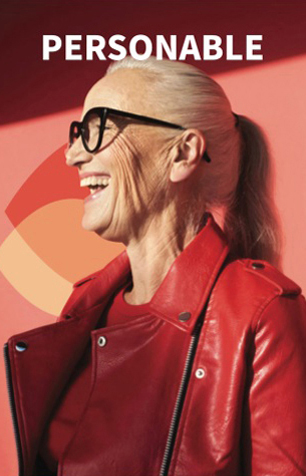 Smiling older woman in red jacket and sunglasses under sunlight